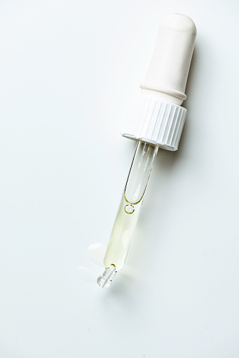 Beauty serum pipette on pure white background.