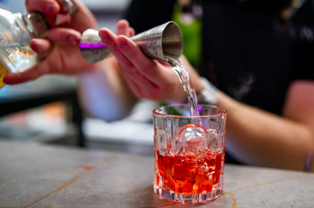 istock bartender hand making negroni cocktail in bar 1697453181