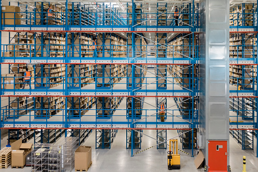 Interior of a modern shipping company. Large shelves and racks in distribution warehouse.