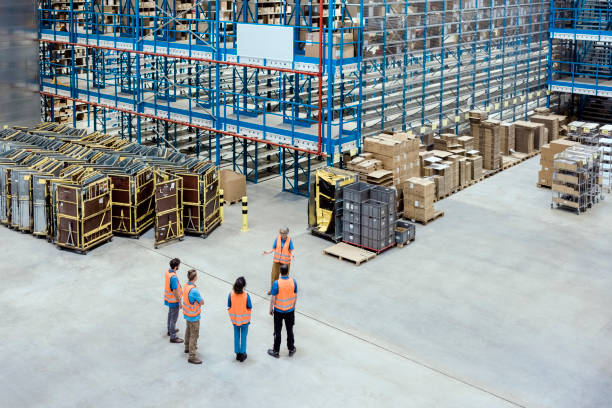 istock Aerial view of a distribution warehouse workers discussing work standing in the plant 1697457576