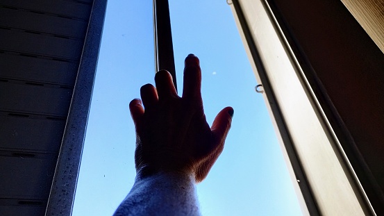 Hand on the apartment window