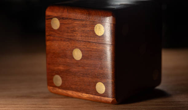 istock Dice, a wooden dice-shaped case for storing small dice, selective focus. 1697495981