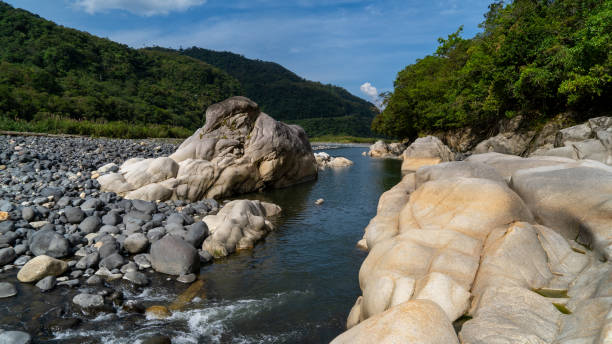 istock Beautiful rainforest river with exotic stones 1697521219