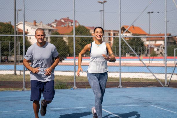 istock Young couple jogging together on summer day 1697522292