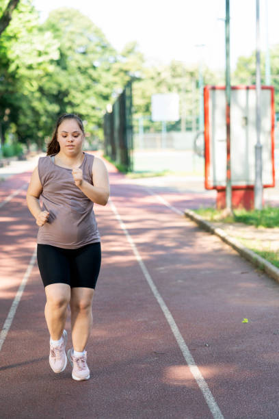 istock Young woman with Down Syndrome exercise 1697568791