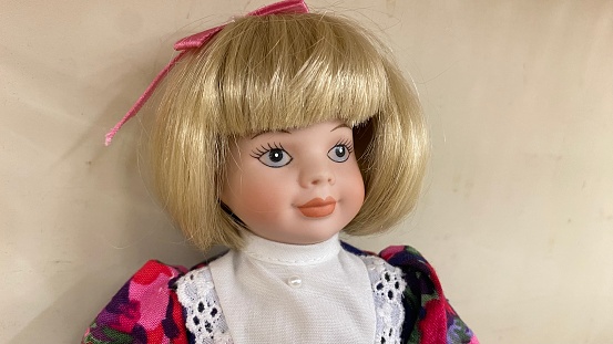 A spooky close up of a vintage baby doll with with creepy eyes.