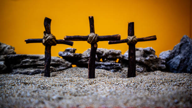 istock crosses stuck in the sand on an orange background 1697755344