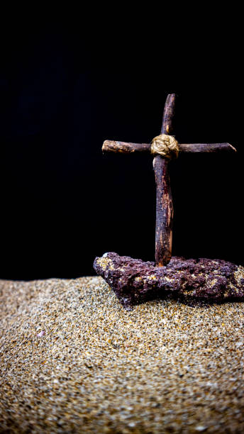 istock wooden cross on black background 1697755345