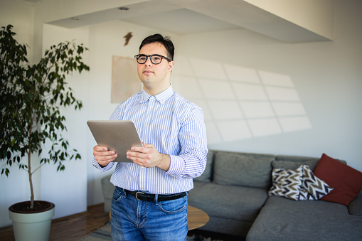 Portrait of a man using a tablet at his living room