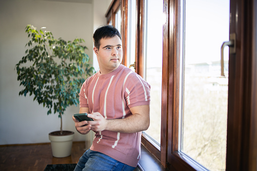 Young man using smartphone at home