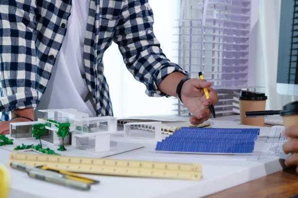 Asian Architect Students Studying Modern House Design and Finding Ways to Utilize Natural Alternative Energy or Use Natural Renewable Energy, Concepts of Eco-Friendly Living for a Sustainable Future.