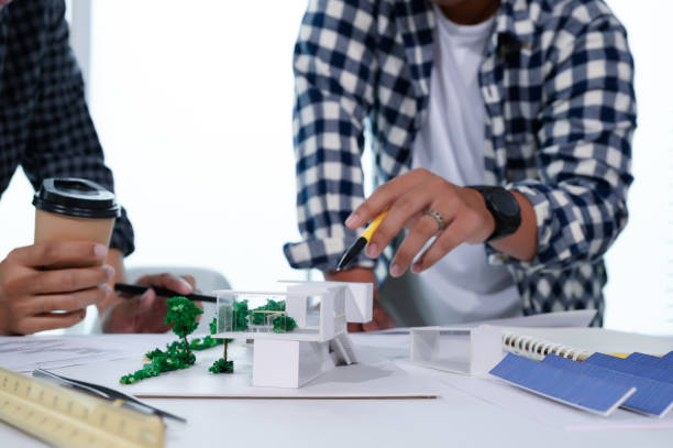 istock Asian Architect Students Studying Modern House Design and Finding Ways to Utilize Natural Alternative Energy or Use Natural Renewable Energy, Concepts of Eco-Friendly Living for a Sustainable Future. 1697805192