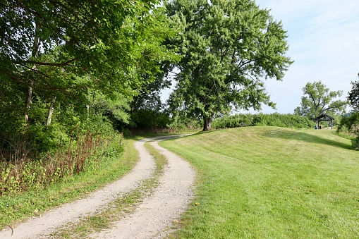 The empty gravel road in the country on a sunny day.