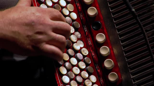 Hand of a Man Playing a Button Accordion. Close Up. 4K Resolution.