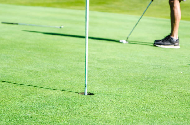 istock Amateur golfer putting ball 1697968859