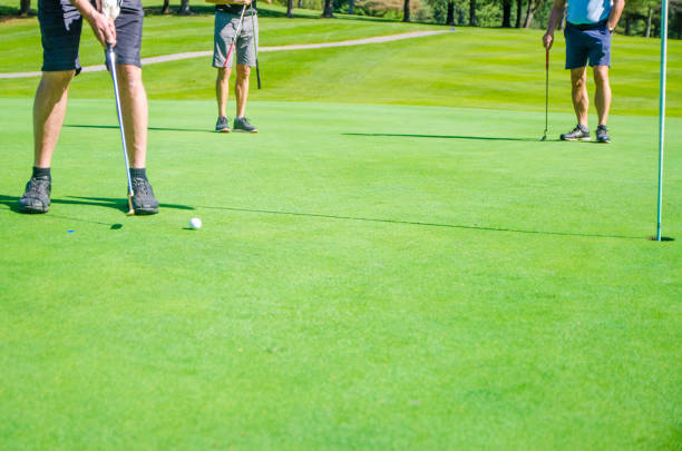 istock Amateur golfer putting ball 1697968883