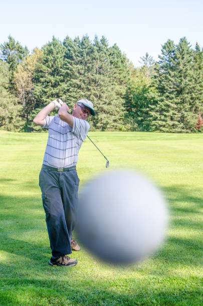 Young Golfer takes a full swing off the tee box towards the greenSee more Golf images in this Lightbox: