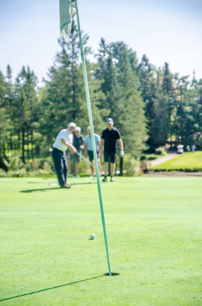 istock Amateur golfer putting ball 1697974873