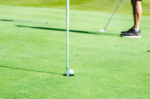 istock Amateur golfer putting ball 1697975979