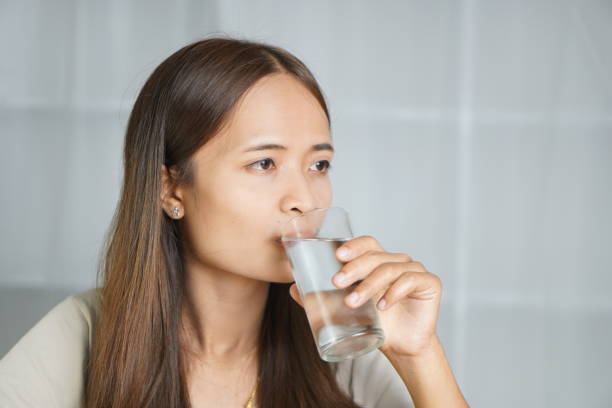 istock Asian woman drinking water, working at home 1698034142