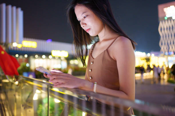 istock Beautiful woman using smartphone 1698054548