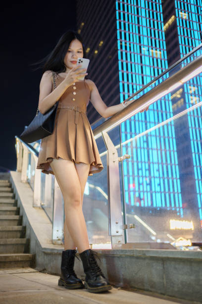 istock woman looking down at mobile phone 1698056677
