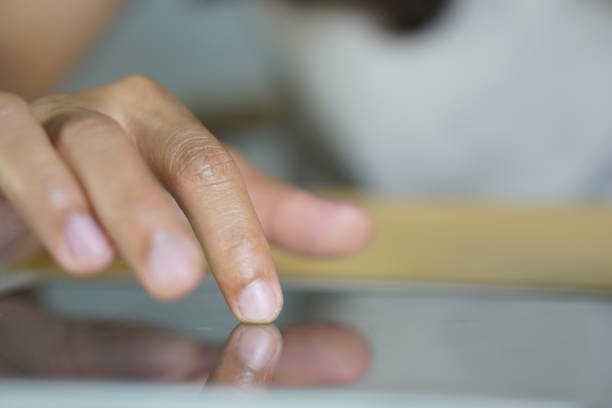 istock Asian woman working at home Use your hand to touch the computer screen. 1698080184