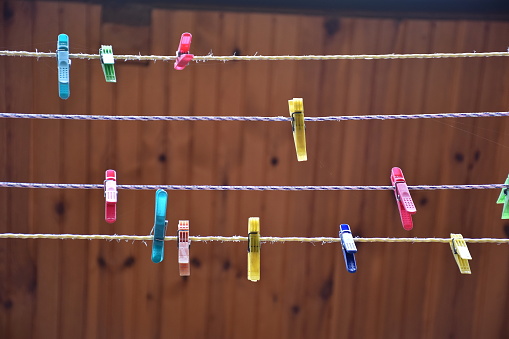 Low angle view of clothespins against wooden background