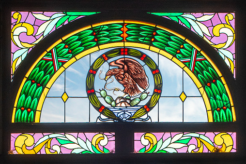 Stained glass window with coat of arms of Mexico