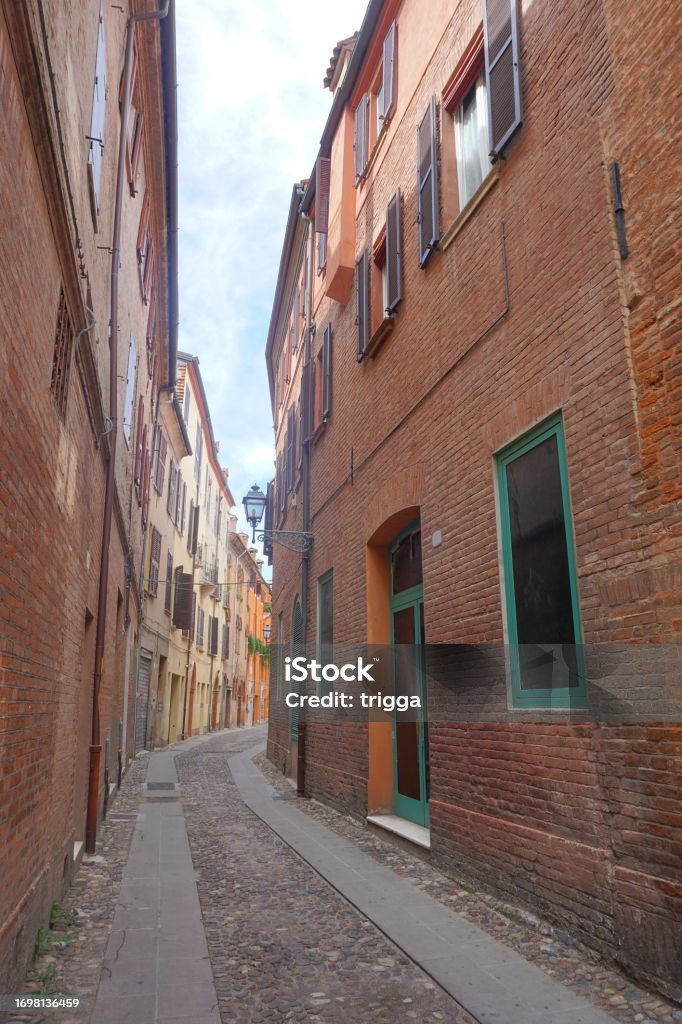 Residential street in Ferrara, Italy Old houses on a narrow street in Ferrara, Italy Alley Stock Photo