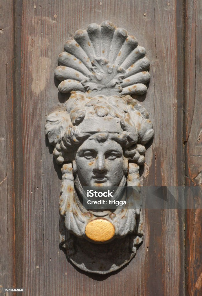 Old Italian door knocker Ornate old door knocker from Ferrara, Italy Ancient Stock Photo