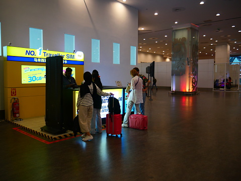 Kuala Lumpur, Malaysia-June 16, 2023: Tourists buying telephone sims at Kuala Lumpur International Airport (KLIA)