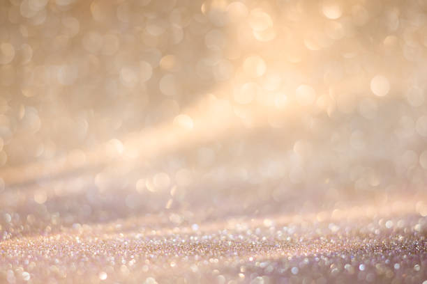 Champagne-colored glitter texture background. New Year and other holidays party backdrop stock photo