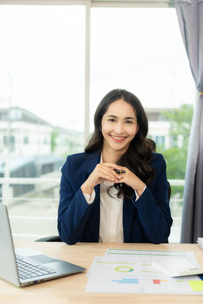 istock Asian business woman office, working with Financial data sheet doing math on office table, taxes, reports, accounting, statistics and analytical research concepts. In the modern office 1698212655