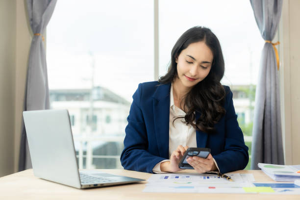 istock Asian business woman office, working with Financial data sheet doing math on office table, taxes, reports, accounting, statistics and analytical research concepts. In the modern office 1698212667