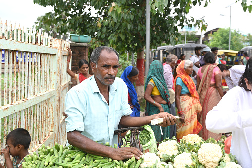 BIHAR, INDIA - August 02, 2023:  Roadside vegetable sellers sell fresh vegetables at the outdoor market in Bihar, India.