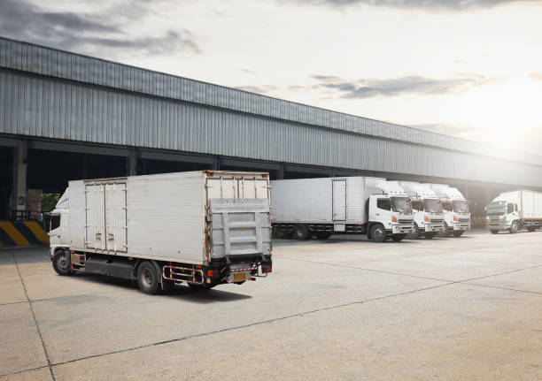 istock Container Trucks on The Parking Lot at Warehouse. Trucks Loading at Dock Warehouse. Shipping Cargo Container Delivery Trucks. Distribution Warehouse. Freight Trucks Logistic, Cargo Transport. 1698247847