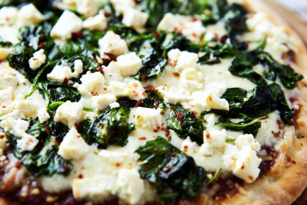 istock Pizza with mozzarella cheese and spinach. Close up. 1698253271