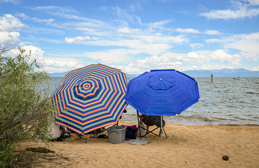 Colourful beach umbrellas on Pope Beach on a summer day. South Lake Tahoe.