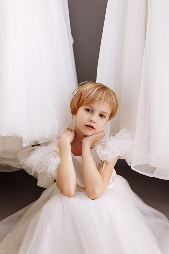 little princess on the bed in classic dress and vintage atmosphere of the room