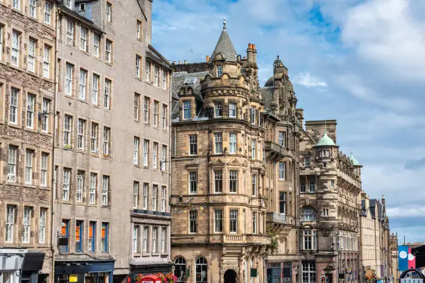 Facades of historic buildings on the busy Royal Mile of the city of Edinburgh, Scotland.