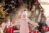 Girl on decorated Christmas street in winter