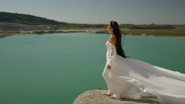 The bride in a white dress on the coast