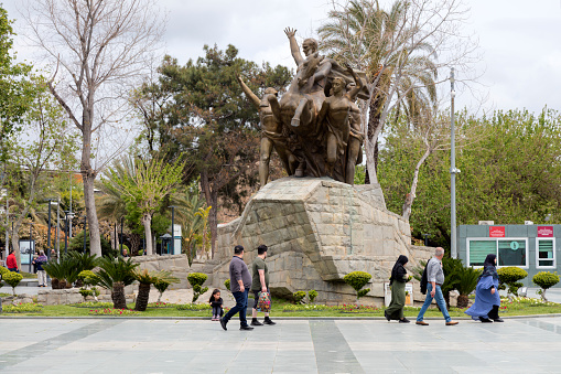 Antalya, Turkey - 26 April: Atatürk Monument and Republic Square in Antalya. The monument features bronze handiwork and was created in 1964. Figures featured at the top include Ataturk mounted on a horse, along with a boy and girl representing the country's youth. The people walking in the Republic Square.