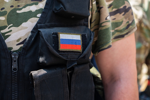 Russian military man with a Russian flag patch. Russian national flag, military chevron.