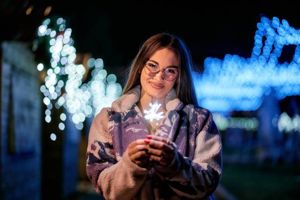 istock Young beautiful woman holding a sparkler 1698288535