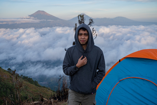 Man hiking to the top mountain of Andong Magelang central java Indonesia.