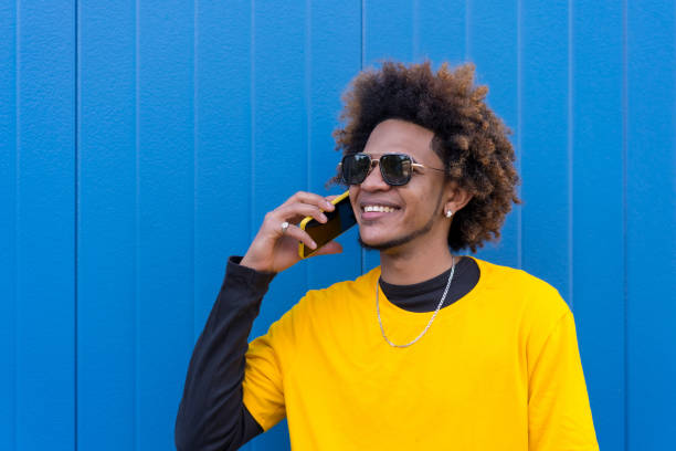 istock Cool african american young man talking to the mobile 1698306705