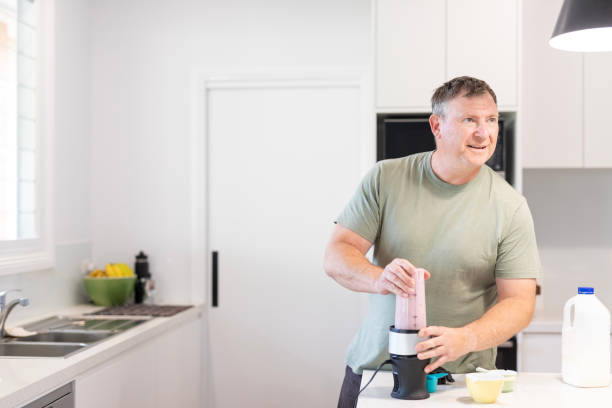 istock Middle aged man making a healthy smoothie 1698307802