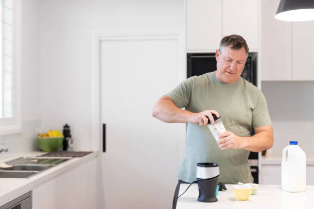 istock Middle aged man making a healthy smoothie 1698307804